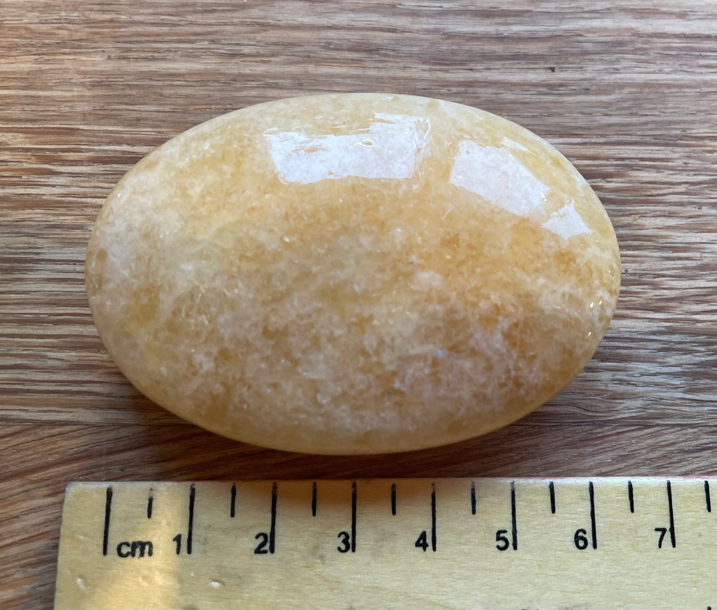 Orange calcite palm stone