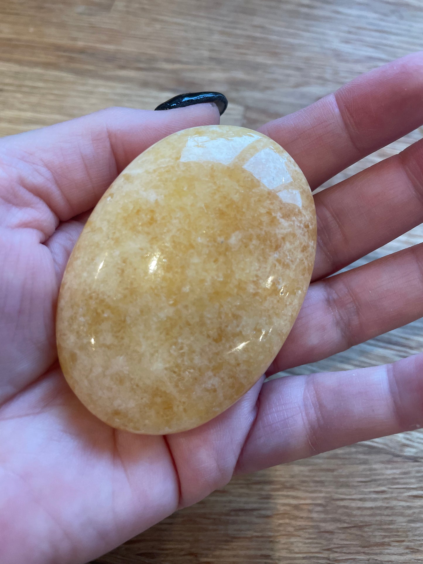 Orange calcite palm stone